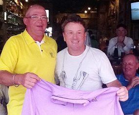Brad Sproxton, left, presents Paul Smith, right, with the champion’s shirt following the June Monthly Medal.